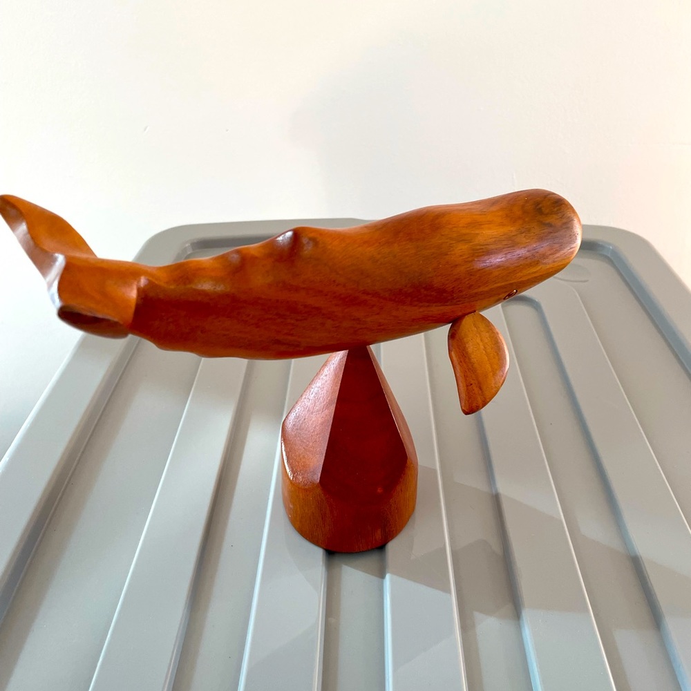 Wood carved beautiful whale on a small pedestal